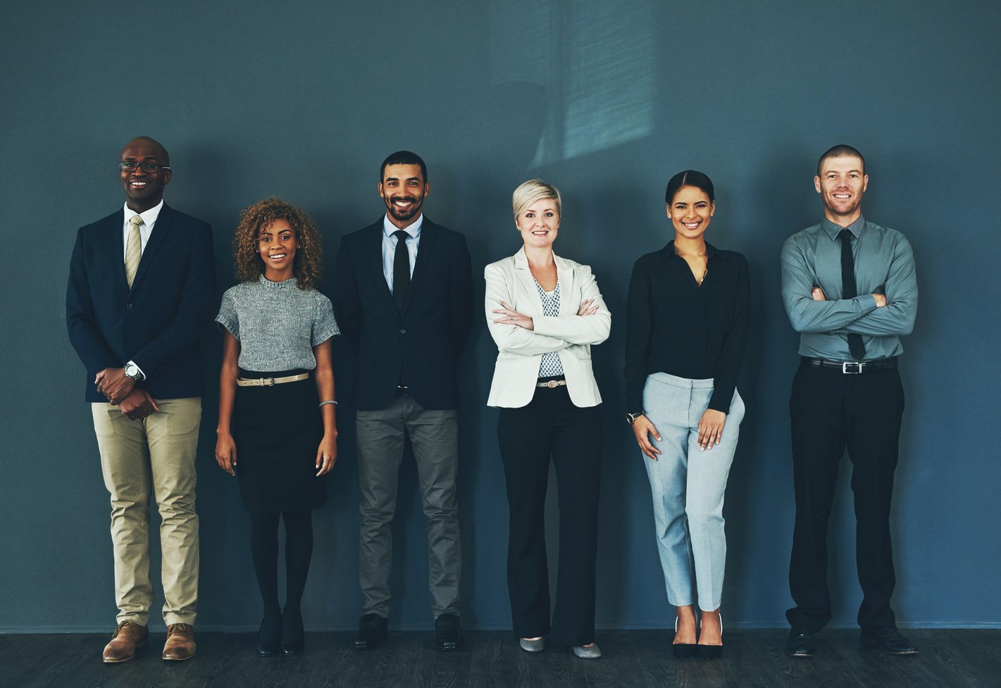 Happy, Smile and Portrait of Business People in Studio for Support, Advisory and Teamwork. Diversity, Collaboration and Professional Lawyer with Employees and Wall Background for Legal Mission